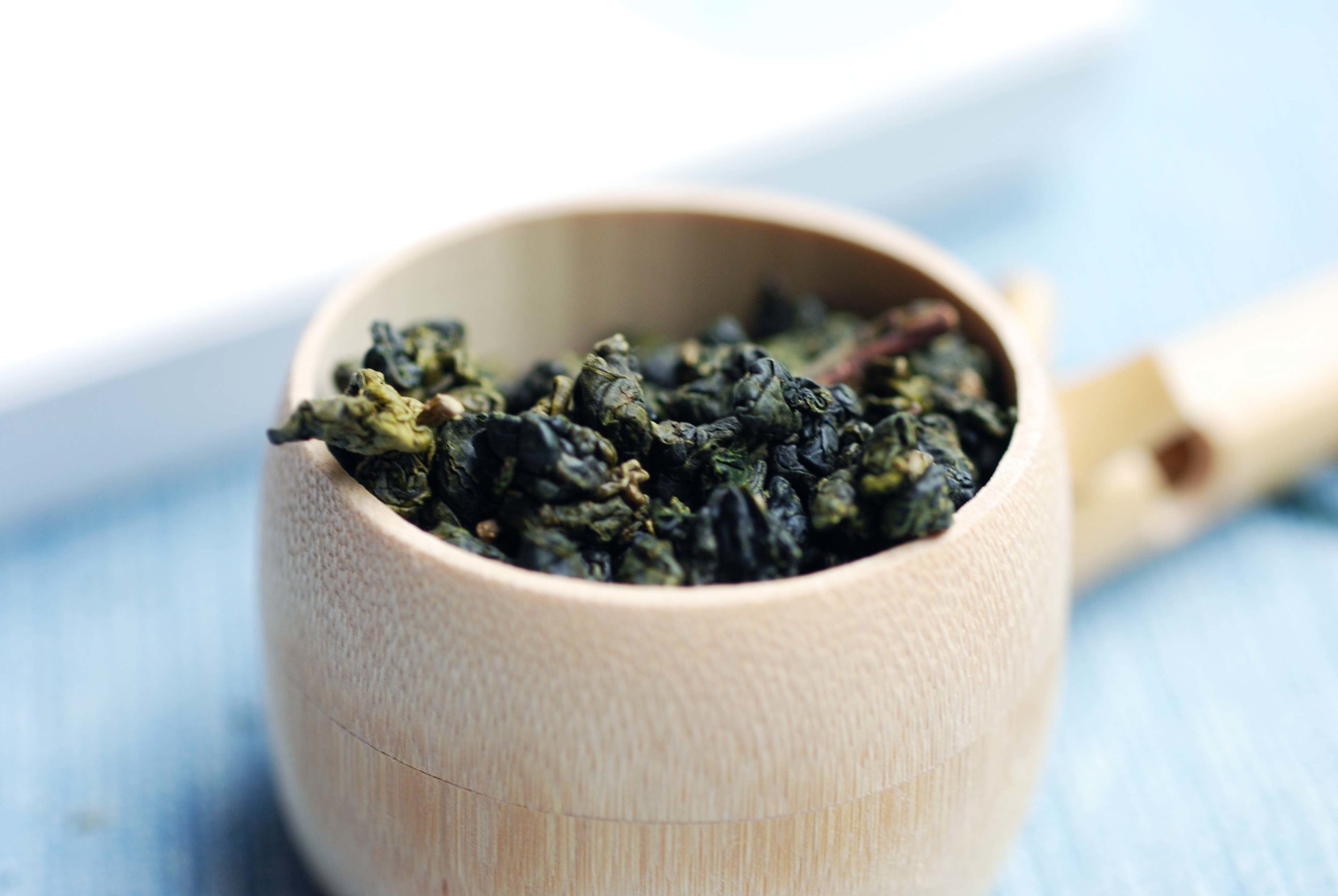 Close up of Qingjin High Mountain Oolong rolled into pea size round balls.
