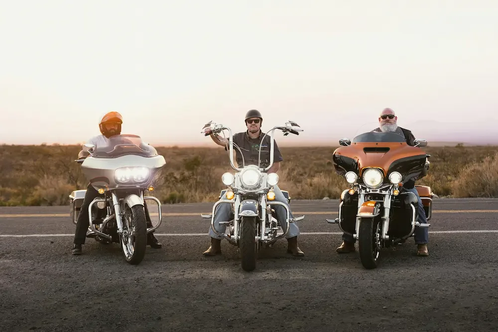 Three touring-style Harley-Davidson motorcycles parked side by side