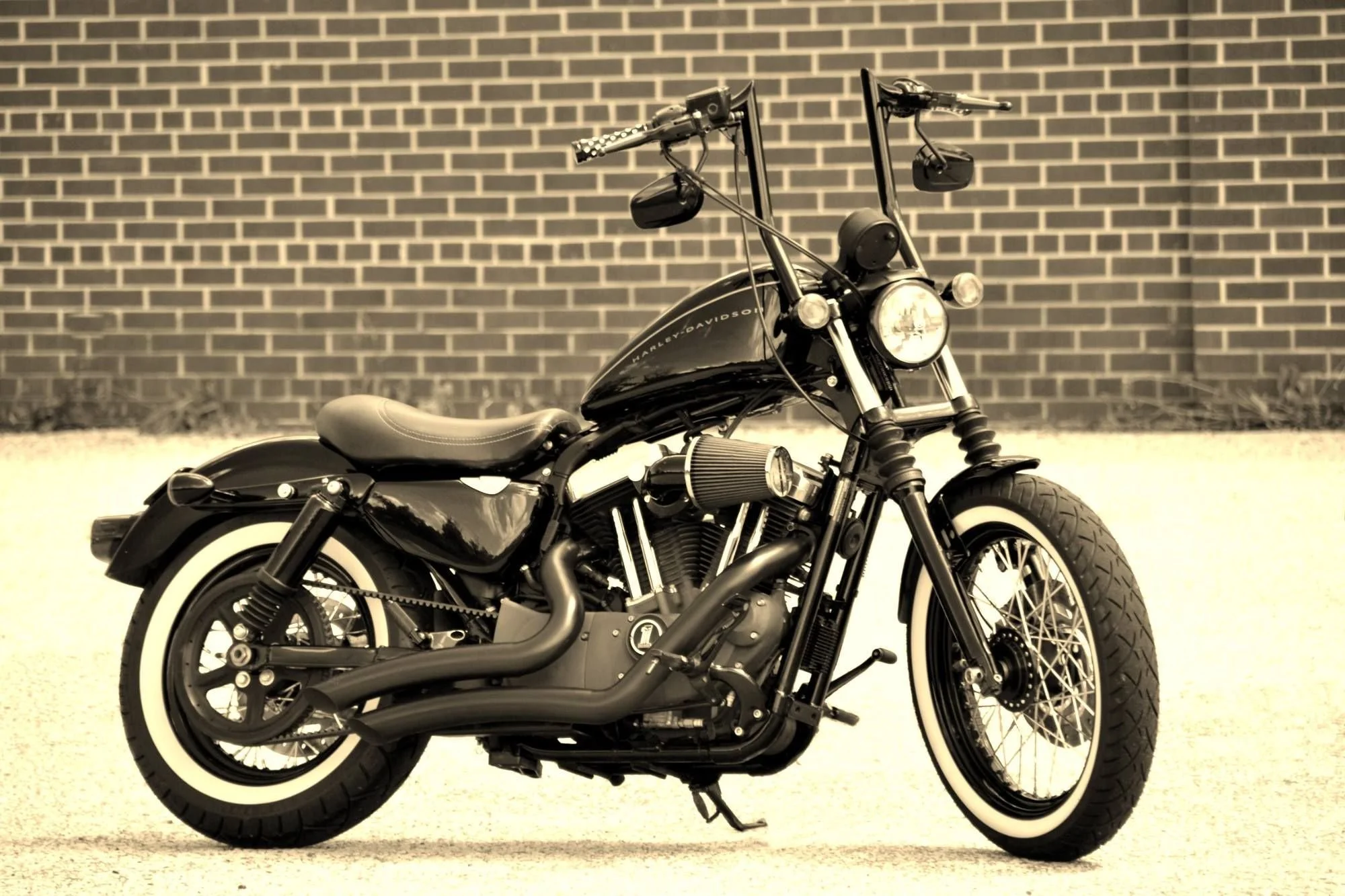 Harley-Davidson Sportster with tall black ape hanger handlebars.
