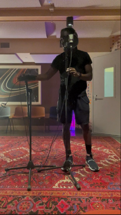 John Kind arranging microphones during an audio recording setup at a Boston studio.