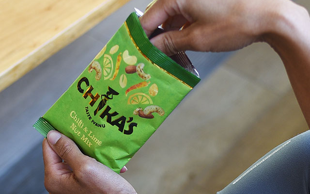hand+in+bag+of+chikas+chilli+and+lime+nuts.png