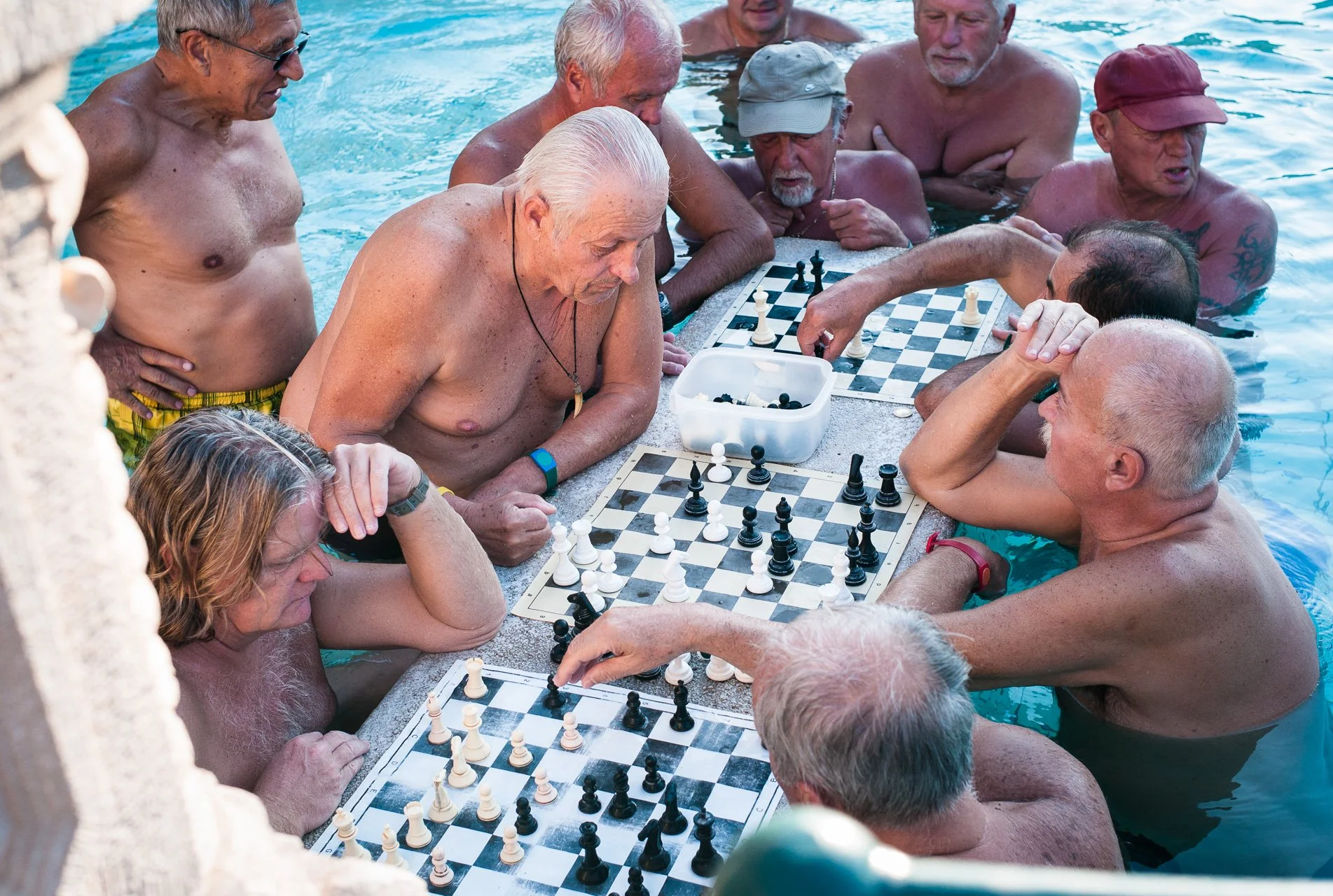 Men gather at a Széchenyi bath pool to engage in two of Hungarians' favorite pastimes: thermal bath and chess.