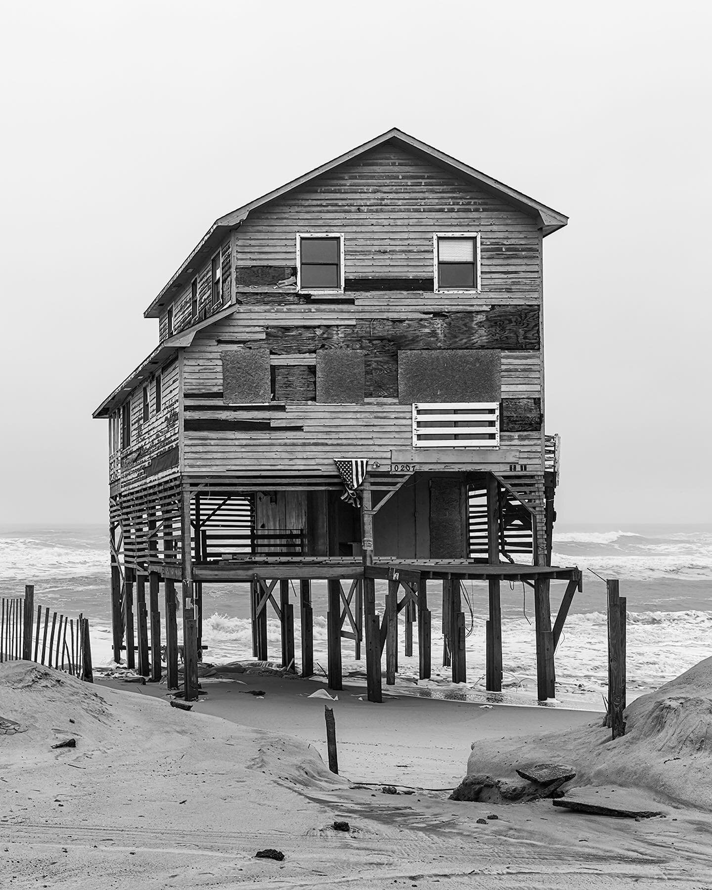 E Seagull Dr II, Nags Head, NC. 2014.

Around Veterans Day in 2009, a powerful nor&rsquo;easter damaged numerous structures along the Outer Banks. These houses on E Seagull Dr in Nags Head were condemned by the town, but stood for years at the center