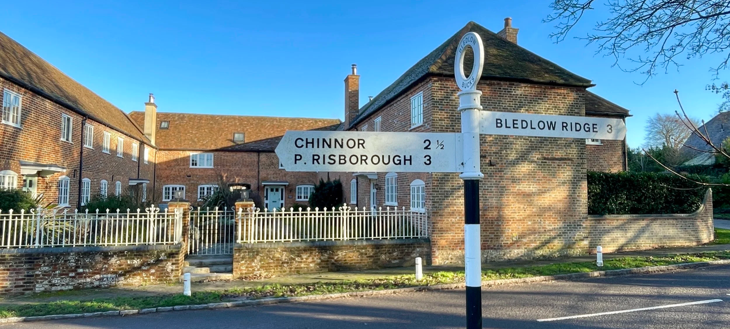 An old Buckinghamshire road sign pointing right to Bledlow Ridge and Left to Chinnor and Princes Risborough