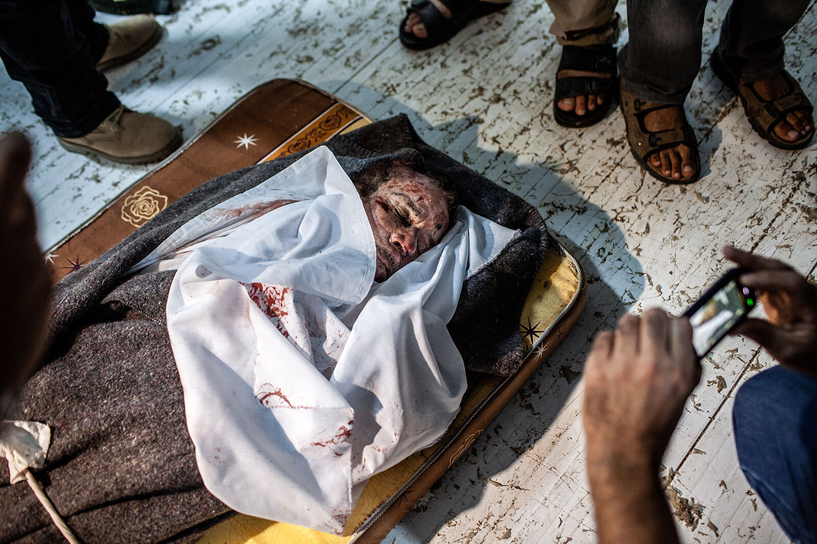  The corpse of deposed Libyan Leader Muhammar Gaddafi is pictured dumped on the floor of a refrigerated&nbsp;meat store on Oct. 2011 in Misrata, Libya. 