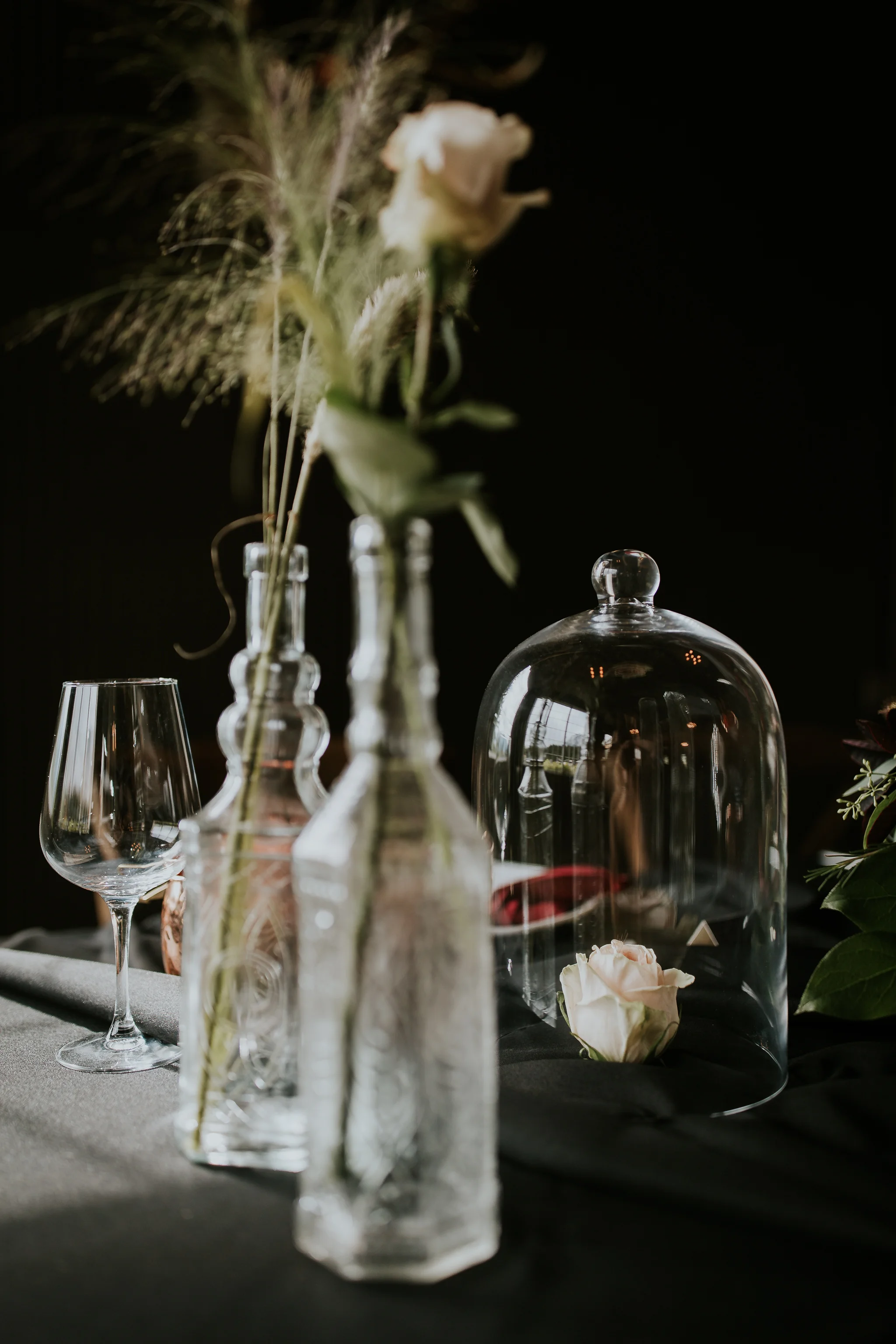 Single rose in tumbler on table like Beauty and the Beast inspired wedding photo