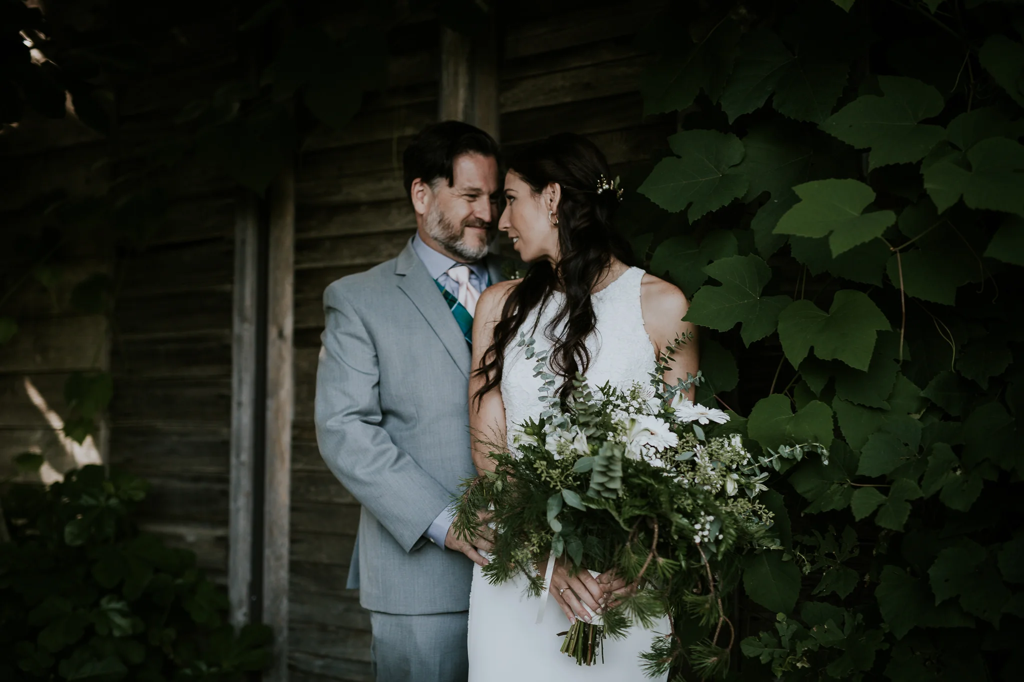 Bride and groom kissing near hydrangeas at Starling Lane winery wedding venue 