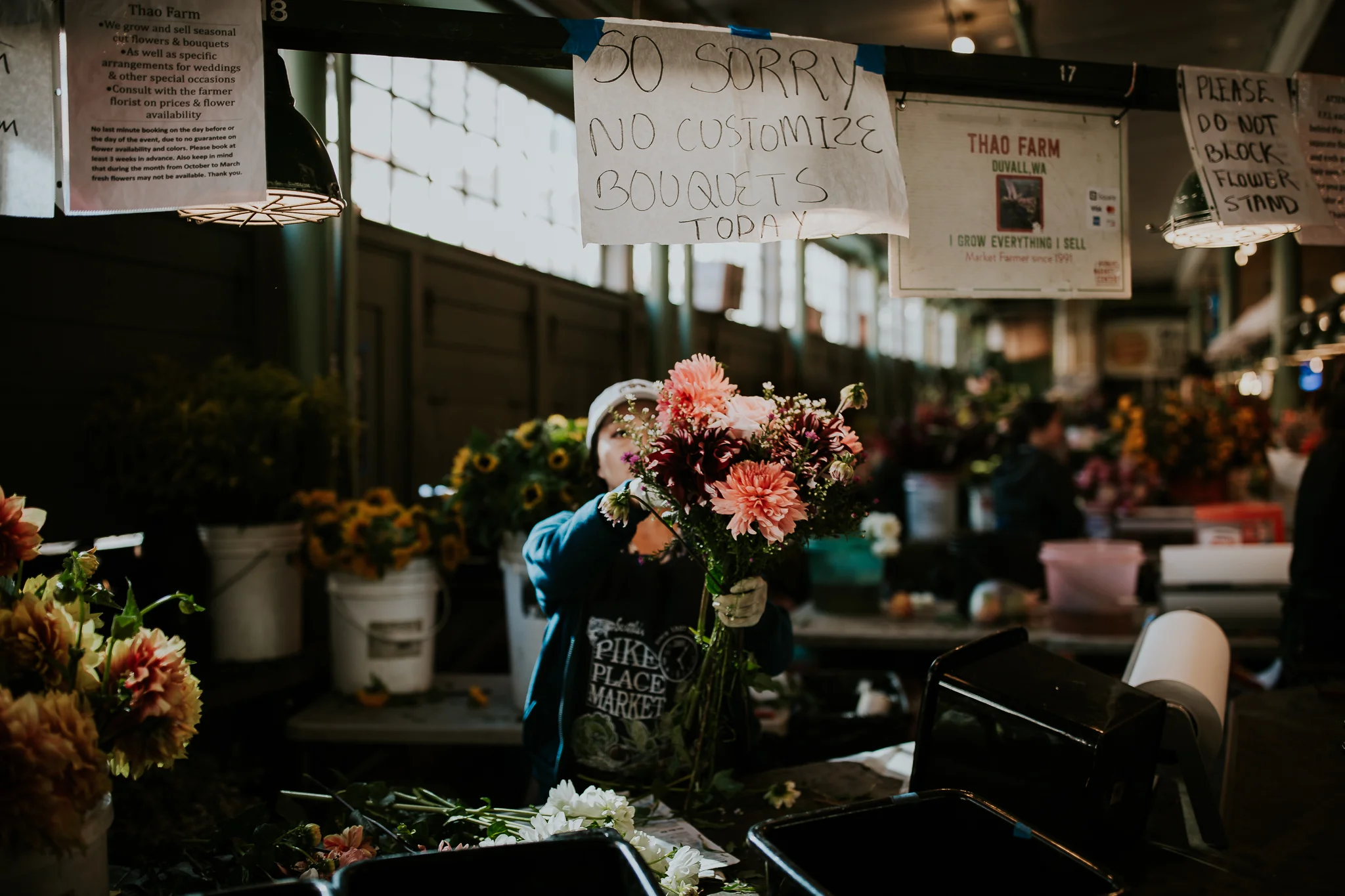 Woman selling fresh flowers at Seattle Public Market