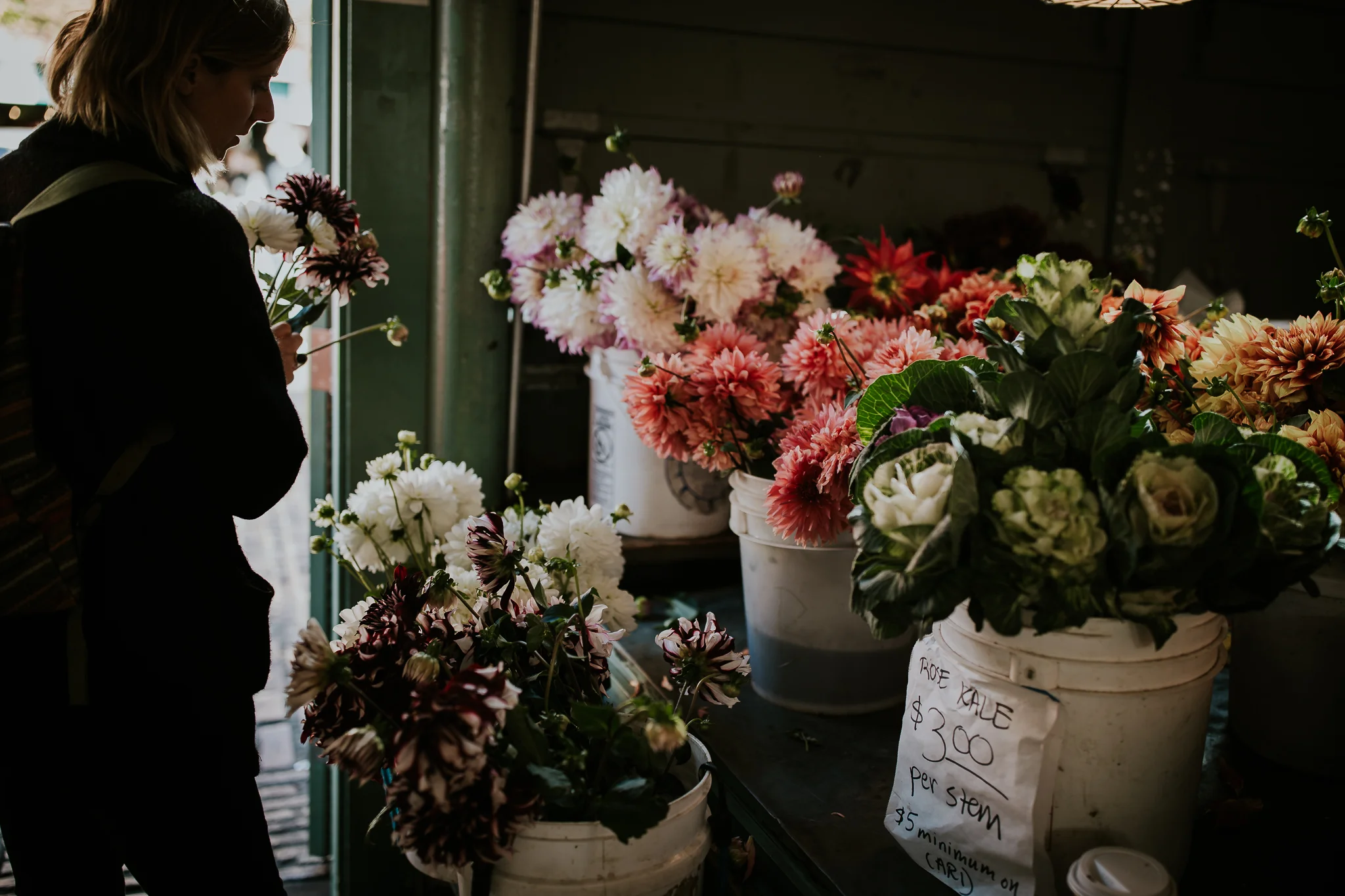 Girl picking flowers for bridal bouquet at Seattle Public Market