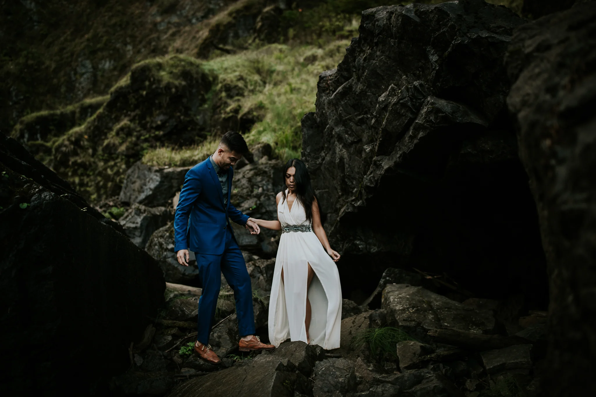 Bride and groom holding hands and laughing at adventurous waterfall elopement near Seattle 