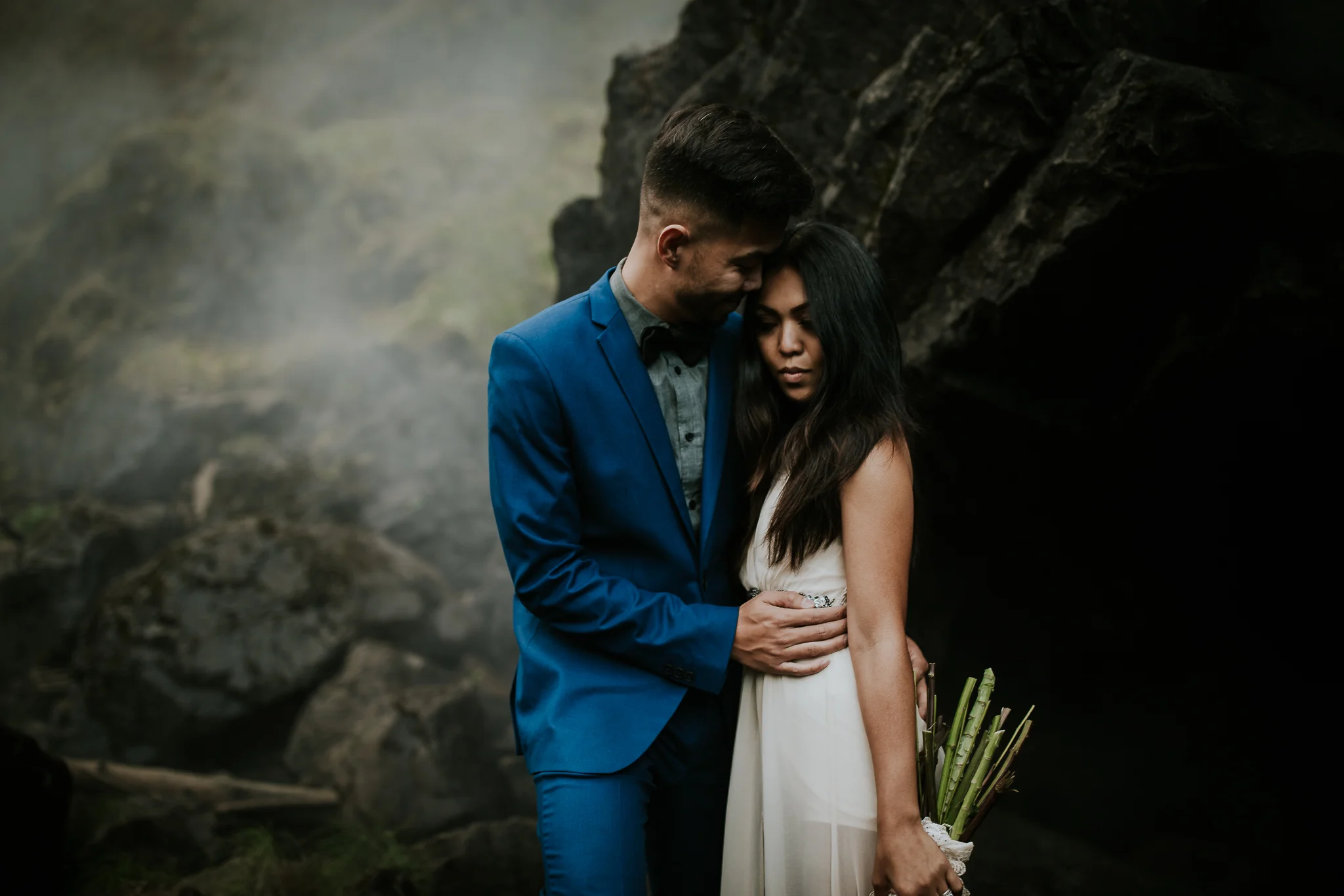 Adventurous bride gazing into camera during waterfall elopement near Seattle