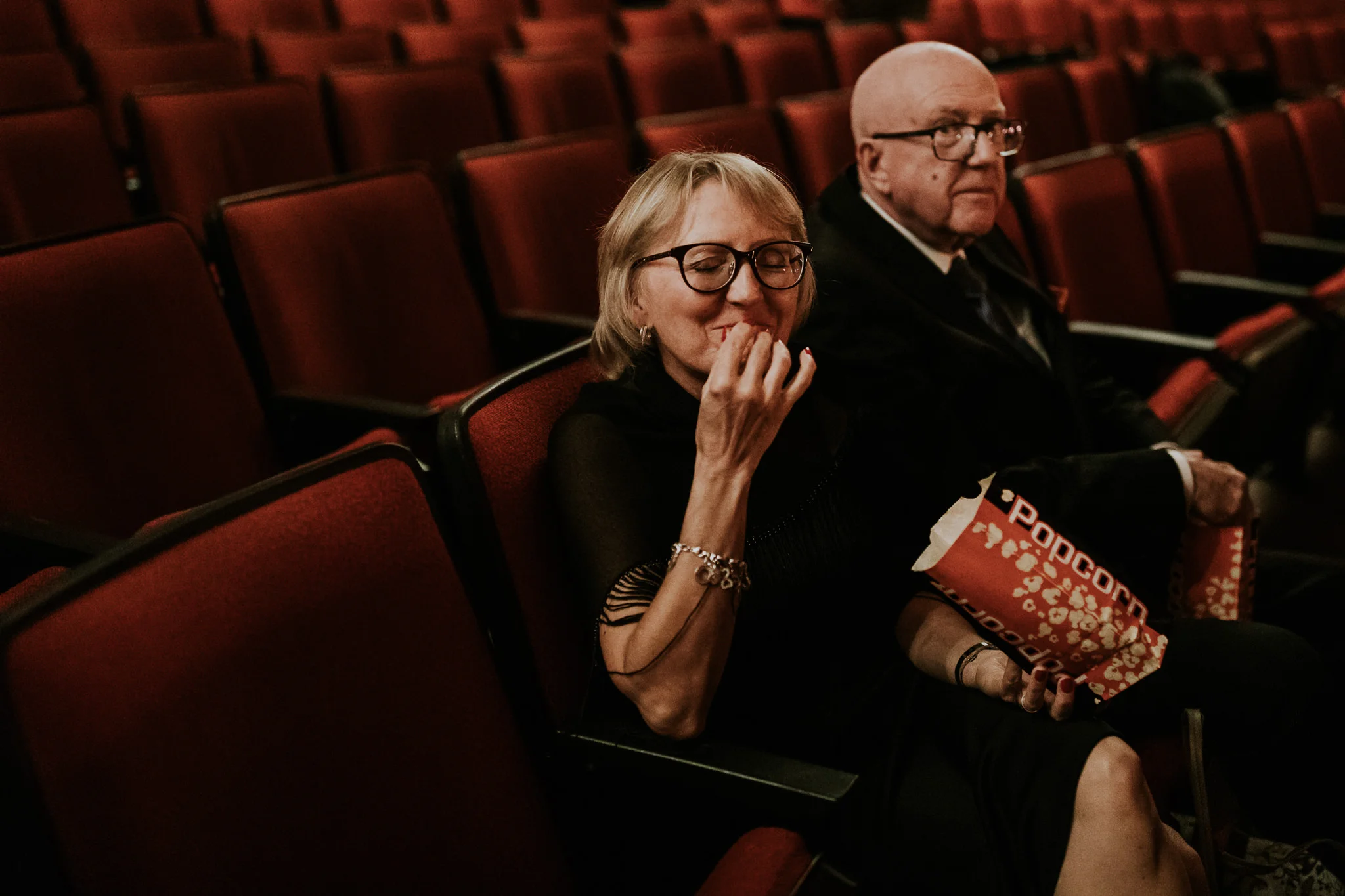 Mother of the bride eating popcorn at the Plaza wedding Calgary