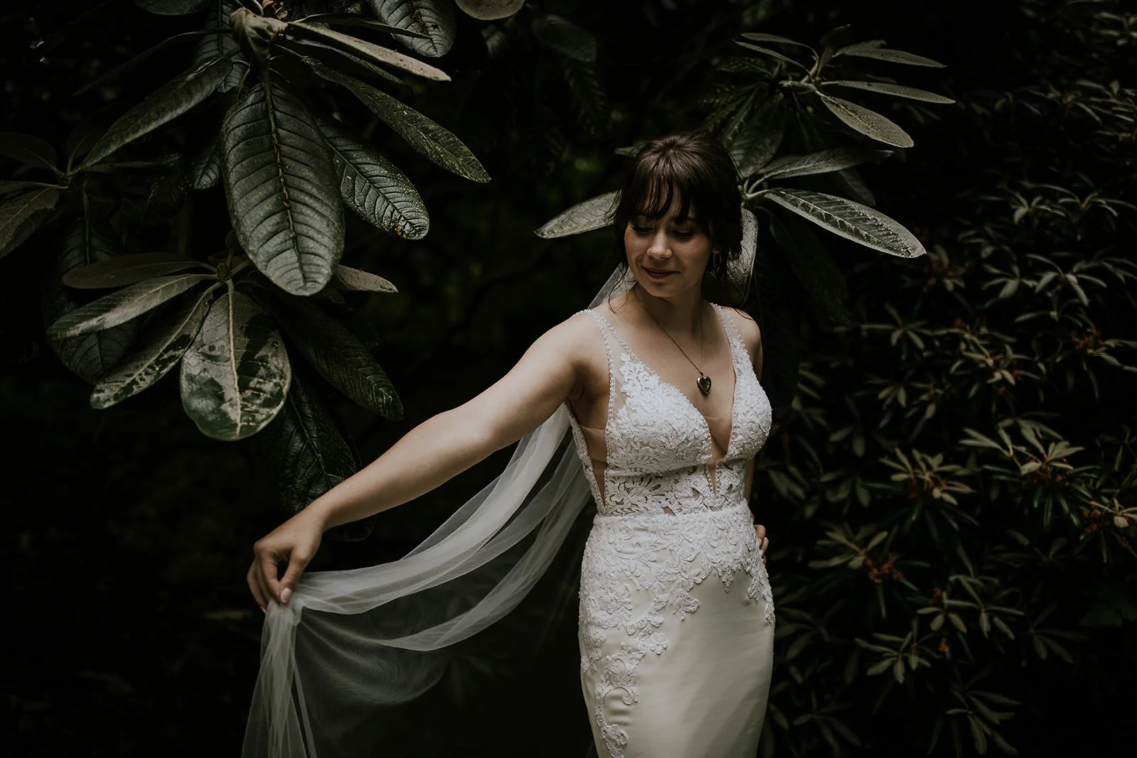 Bride posing with veil in front of jungle plants  during Sayulita wedding photos 