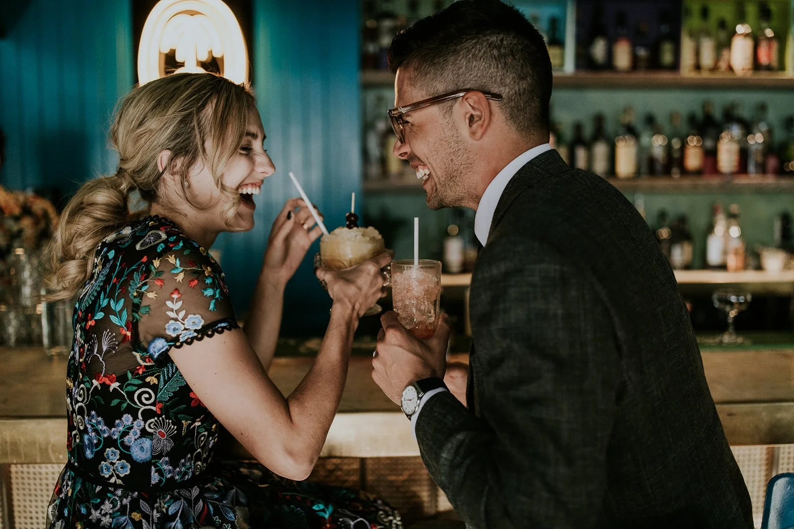  bride and groom sipping on cocktails during tropical destination wedding 