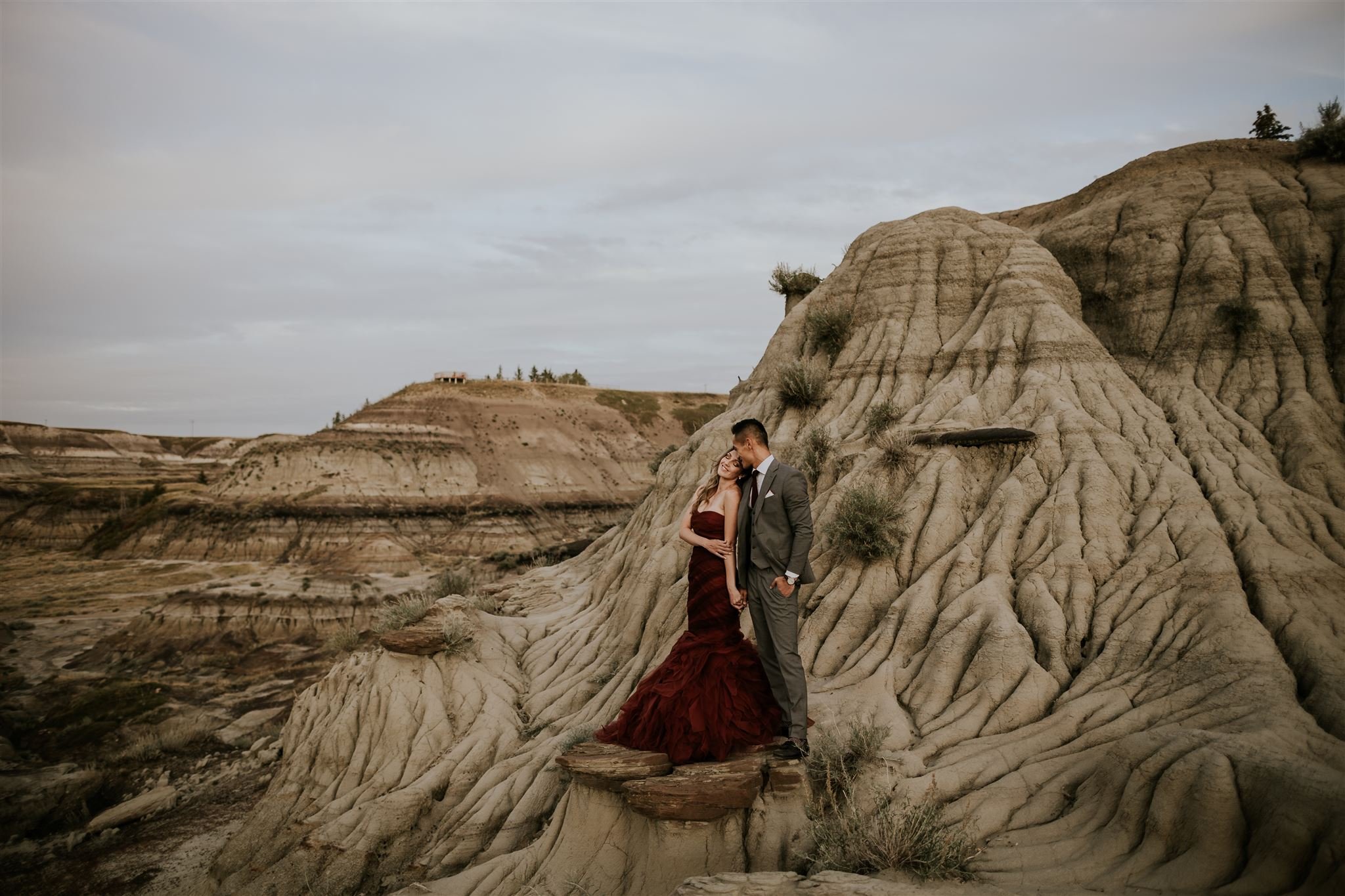  bride and groom posing on hoodoos during destination wedding 