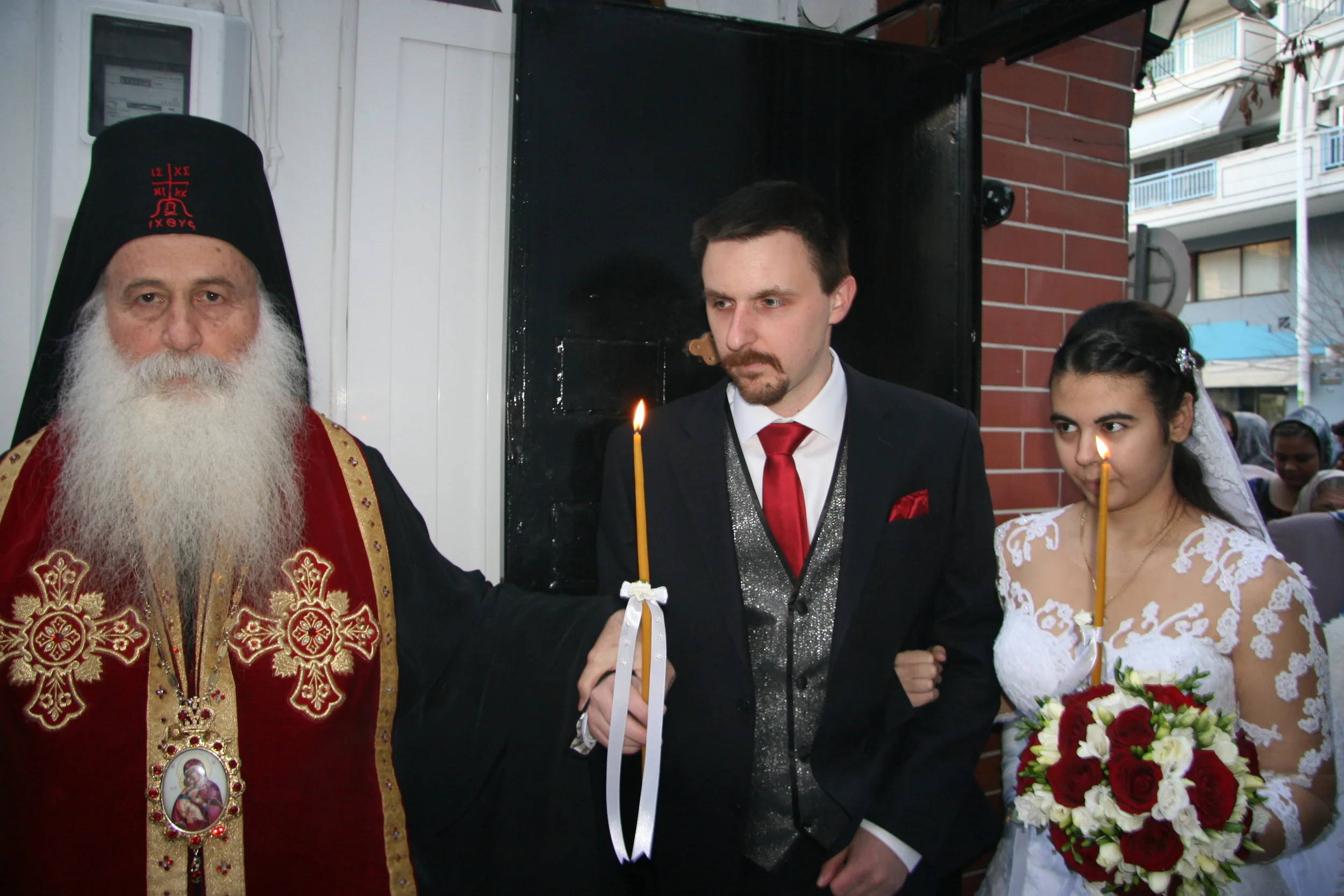 Bishop leads them to the church entrance