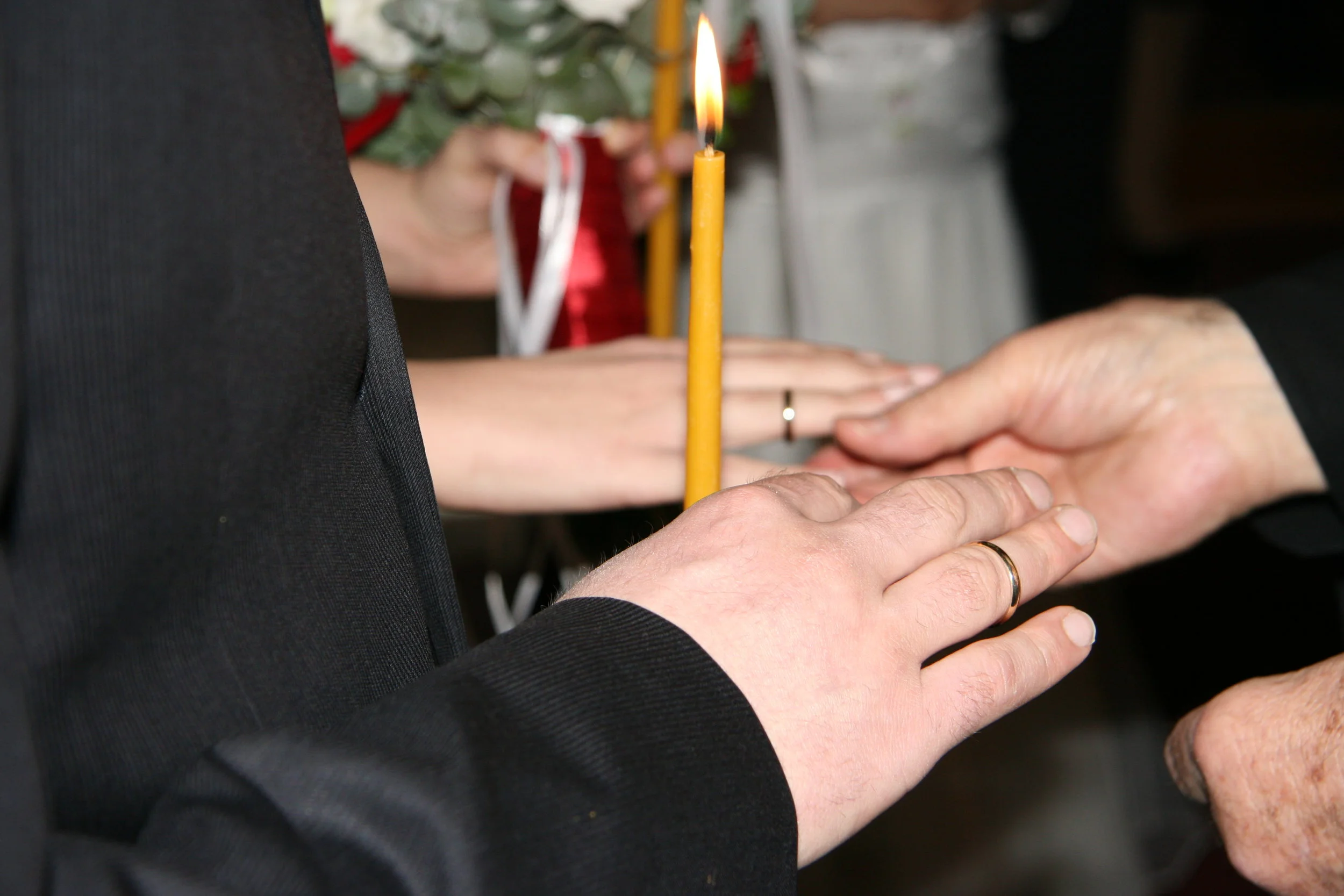 Bishop puts the rings on halfway, so the best man can …