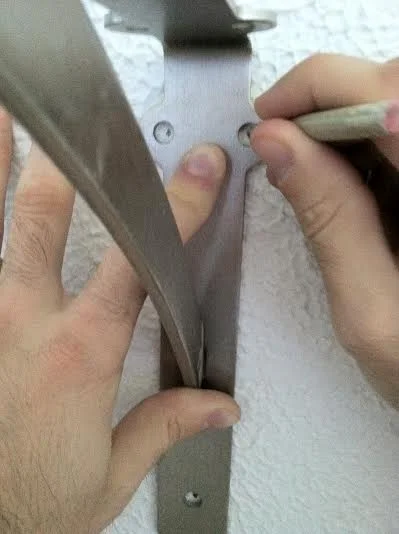  Measure and mark with a pencil where you want your brackets to hang, then mark the holes where your anchors and screws will go.