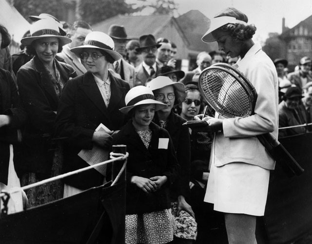 1937 American tennis player Alice Marble signs autographs for young fans