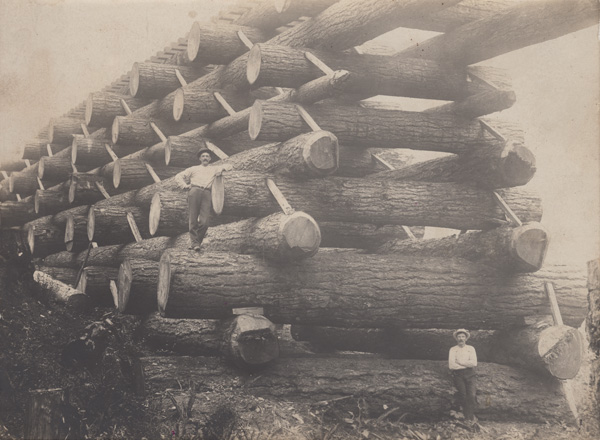 Erik Andreas Persson (upper left) posing for a photograph on a newly finished railroad bridge. (1903-4)