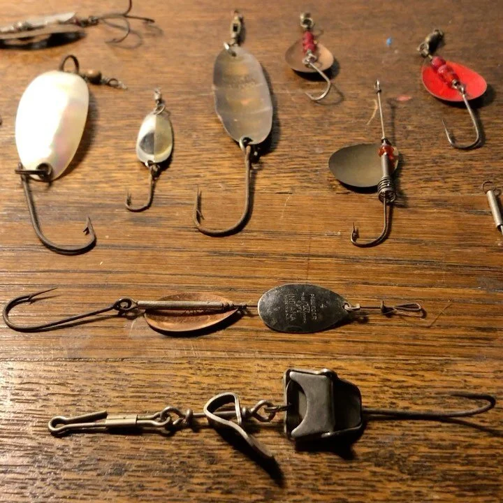 Antique spinners and spoons. 20s, 30s, 40s; An abundance of vintage fishing tackle from the Collection. A few with fine detail and quite old. Many manufacture&rsquo;s boxes with antique fishing gear.