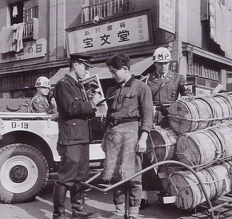 A policeman confiscates goods in 1949.