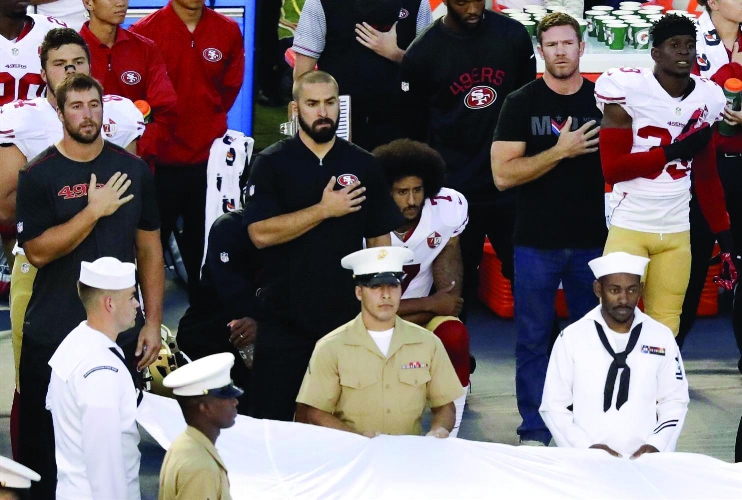 Kaepernick sitting down during the national anthem. | PC: nbcnews.com