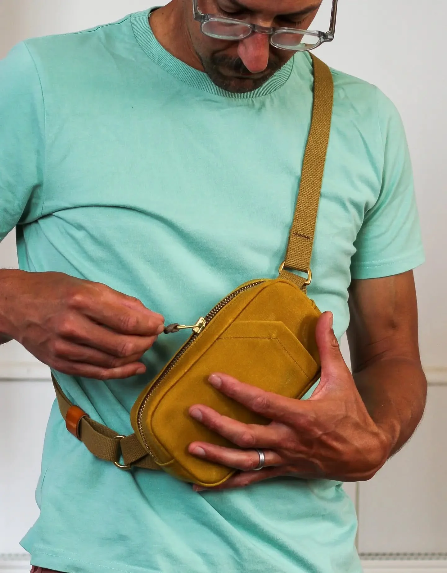 A fun little project made last week in the heat wave enforced break from building work. A custom sling bag, loosely based on our bum bag, with the brief to create a wedding organisers dream bag.

Designed to fit a phone, with quick front pocket acces