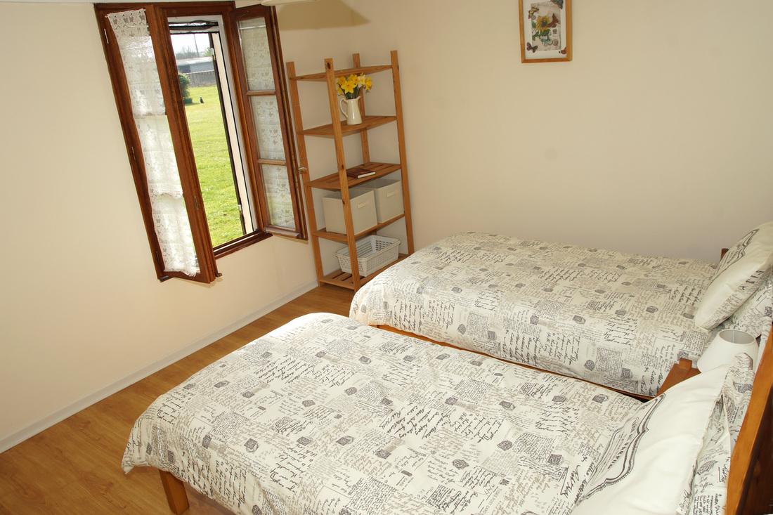 Twin bedroom with views across garden
