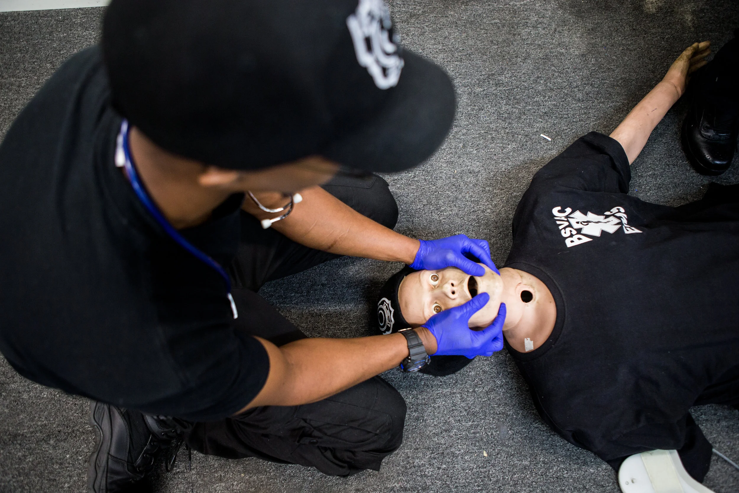 Using a patient simulation mannequin, Alonzo Culbert, 30, practices CPR.
