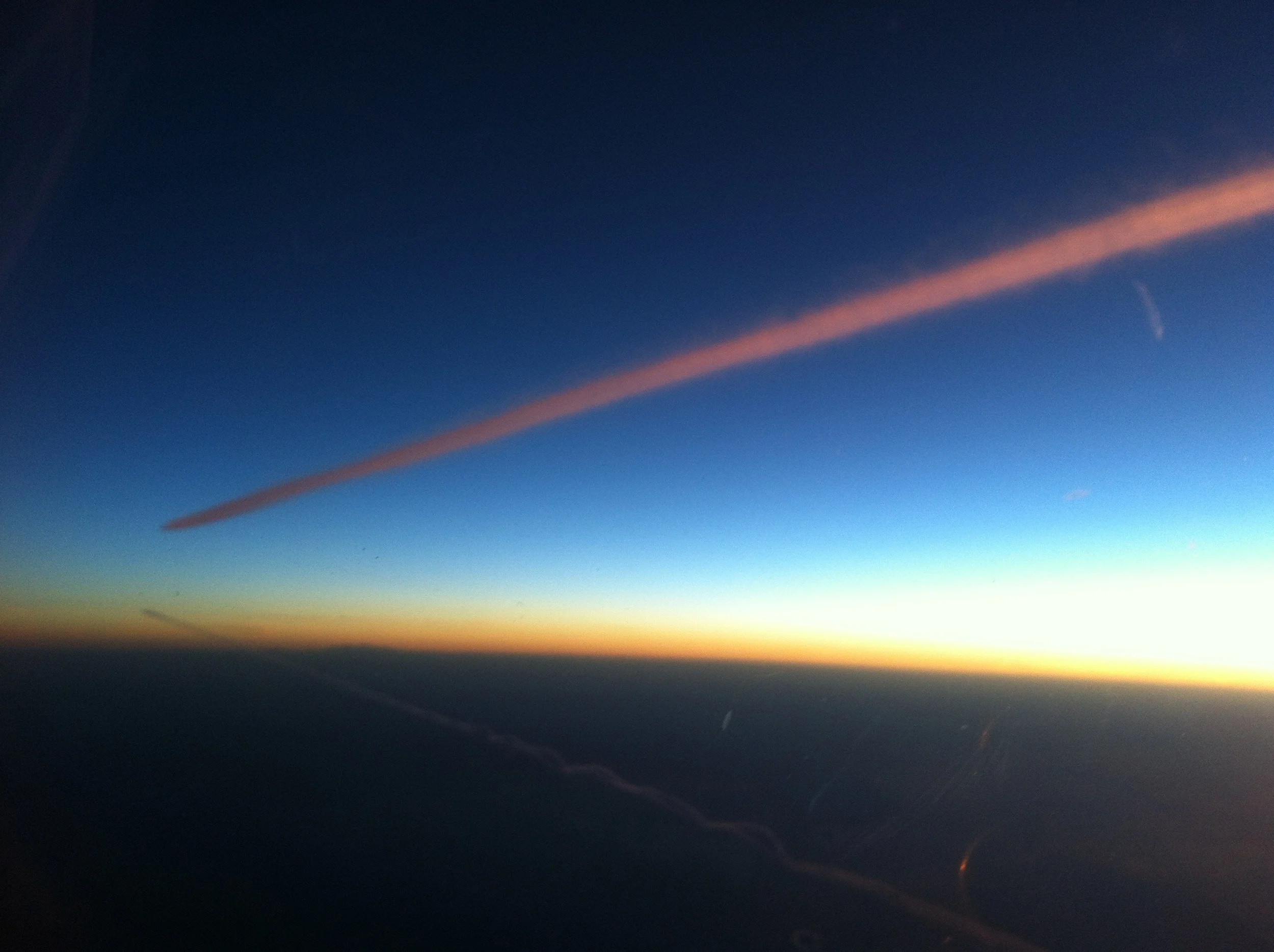 Contrails at dawn over the Mediterranean
