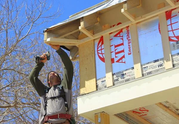 Pollard installs blocking for soffit nailing at the corner of the eave.