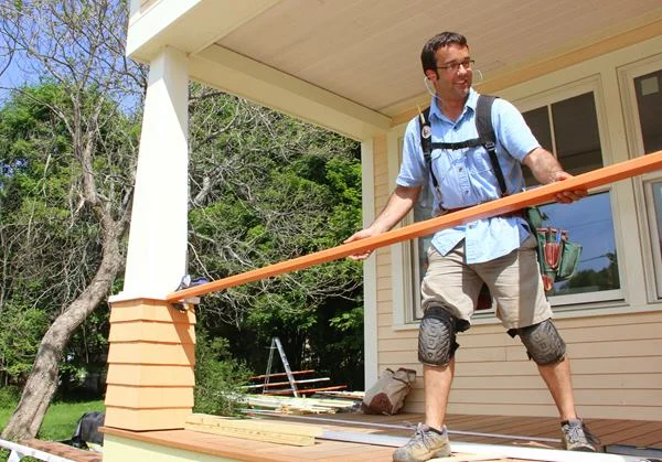 Pollard sets the top rail in place.