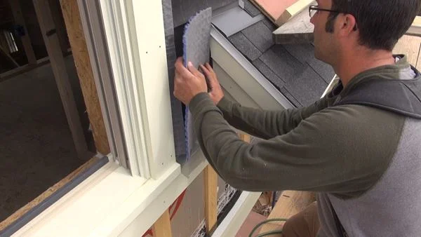 Pollard fits a small scrap of Mortairvent into place on the front wall of the dormer.