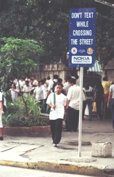Helpful phone safety sign, Manila. (JAMES FLINT)
