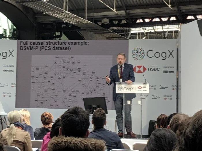 Dr. Freestone continues his lecture at CogX19, with an example of a full causal graph.