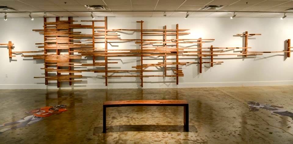 Frame Out by Nick Gilmore, salvaged dade county pine lumber, 8'h x 35' long, 2014. Bench: black walnut w/dade county pine inlay, (57" x 12" x 18" h), 2014