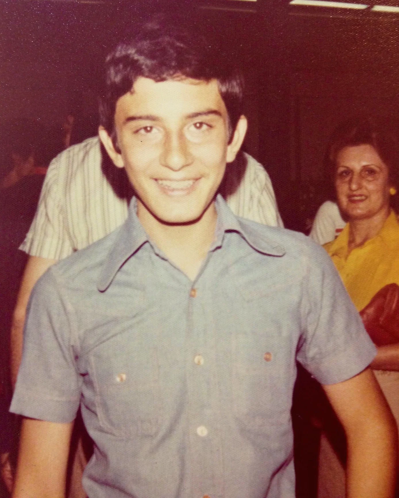 Me, moments before I boarded the plane to the US in Tehran in 1978. I can't imagine what my mom (in the background) was thinking/feeling at that moment.