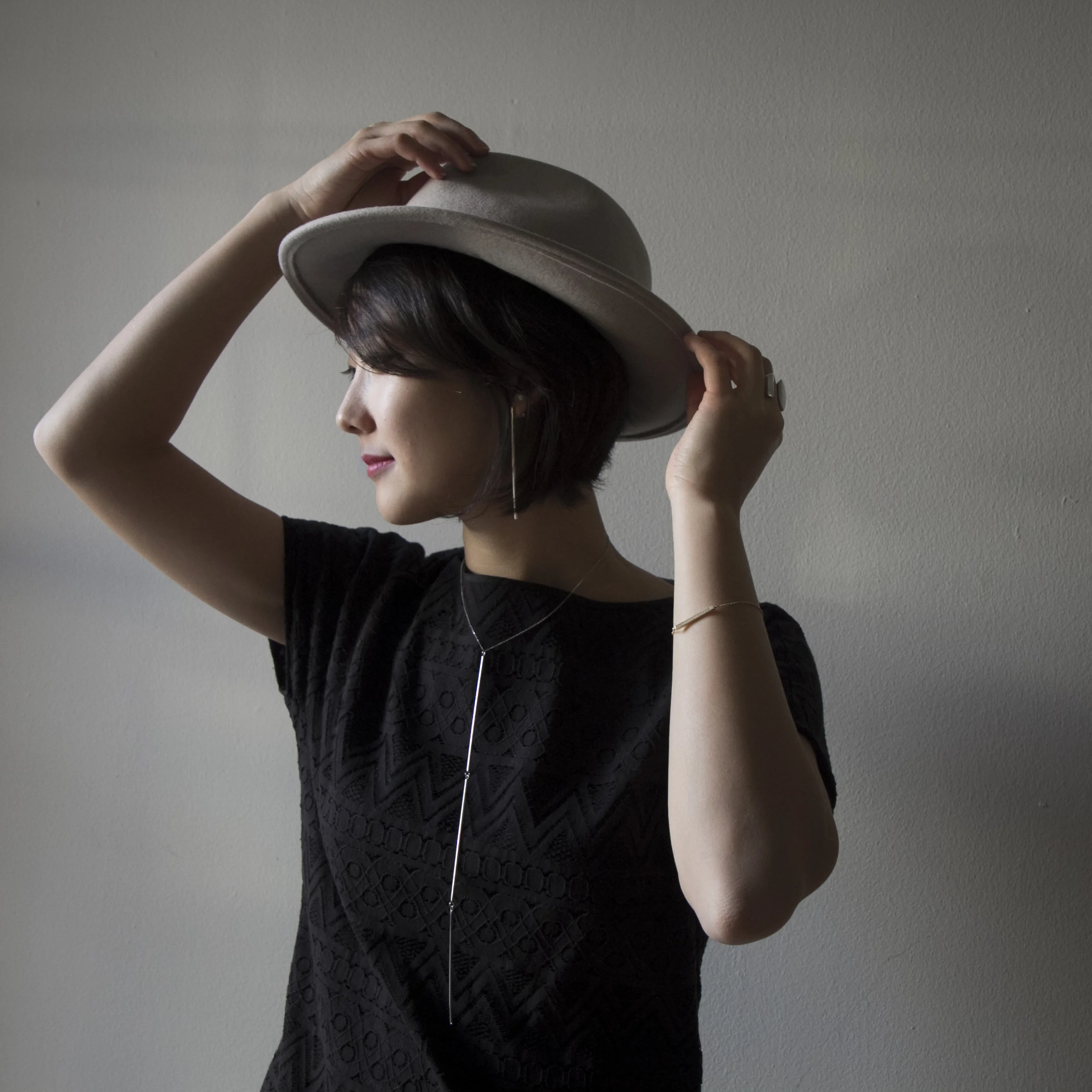 Co-Founder Judy Suh wearing the Triple Line necklace