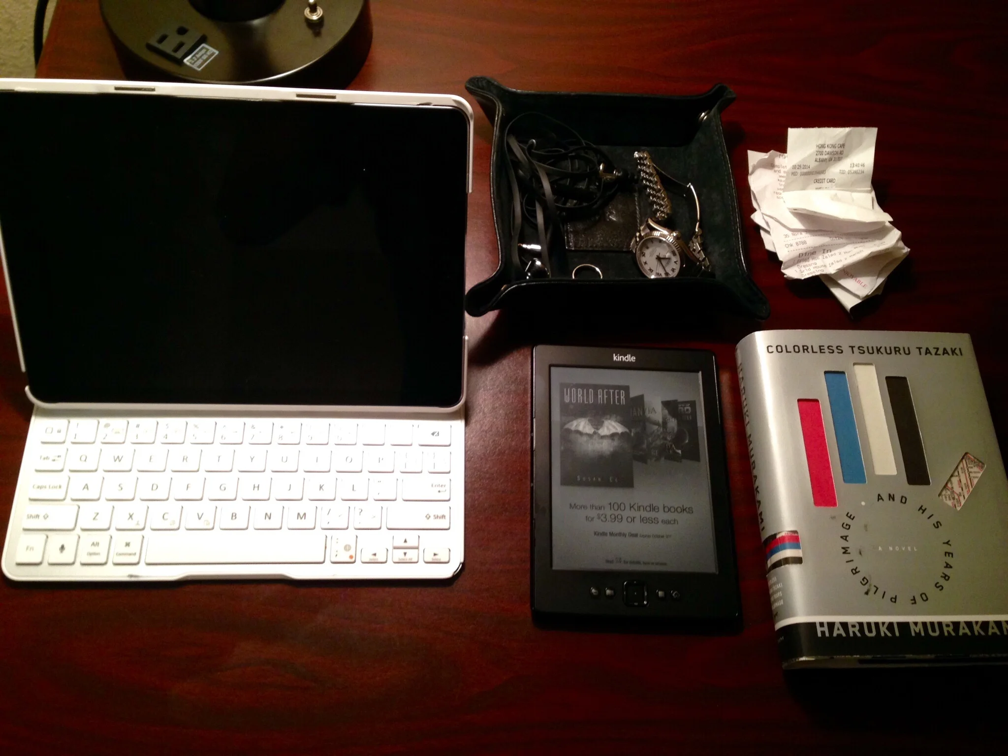 My iPad has completely replaced my laptop since many years ago. The Belkin bluetooth keyboard/case makes it possible for me to do some heavy duty work on this iPad. I recently started carrying my Kindle again and am amazed how easy it is to read on it. I also started reading the addictive Murakami and brought a physical copy just in case. Finally, the leather tray helps me not to leave any valuables behind when I check in and out of different places. 