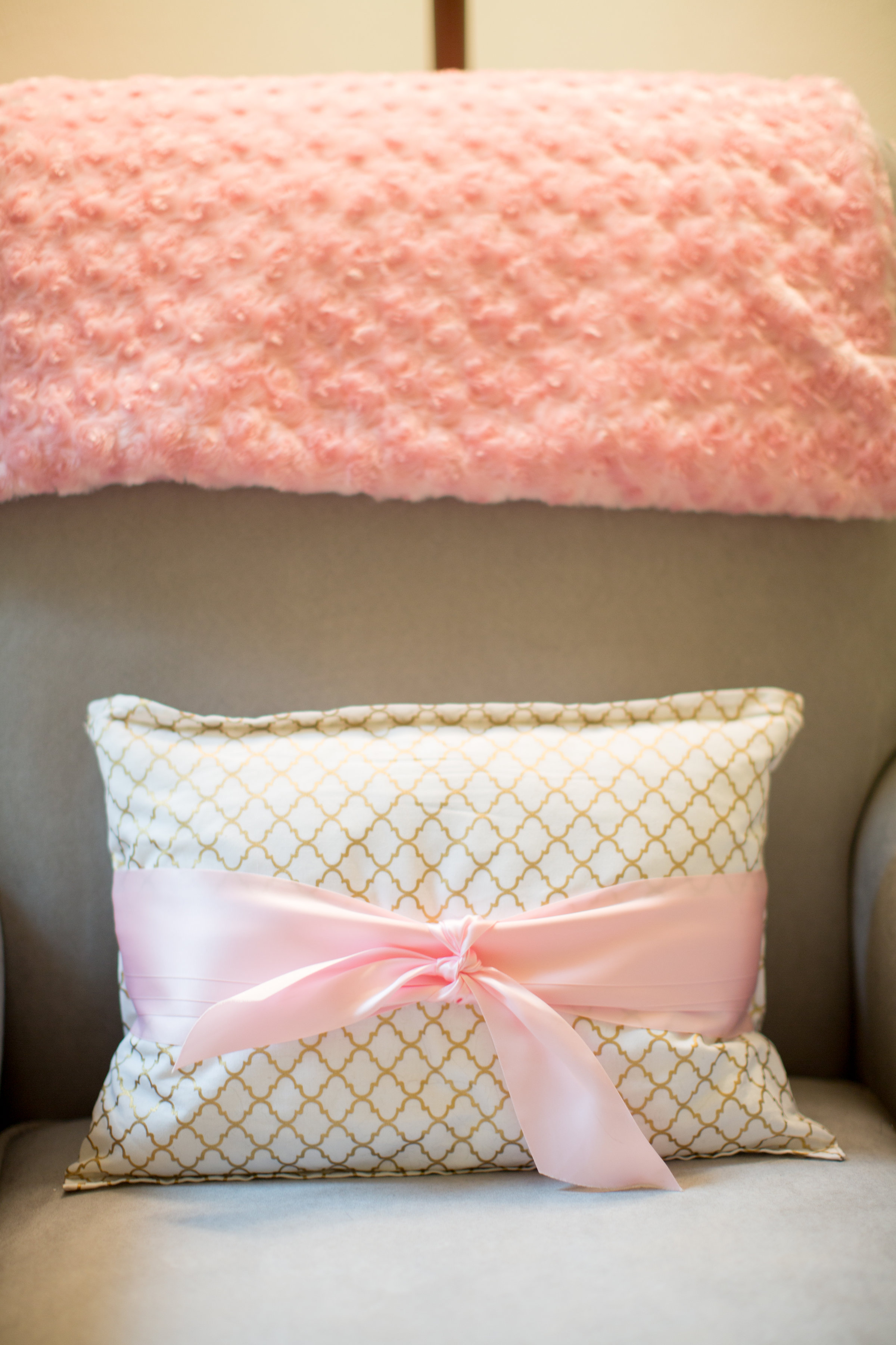 My momma made this beautiful pillow. She got fabric that matched the ribbon valance and finished it off with a sweet little bow. The pink blanket was made for me and baby by my aunt Linda. She made it big enough so we could cuddle up together. I love it.