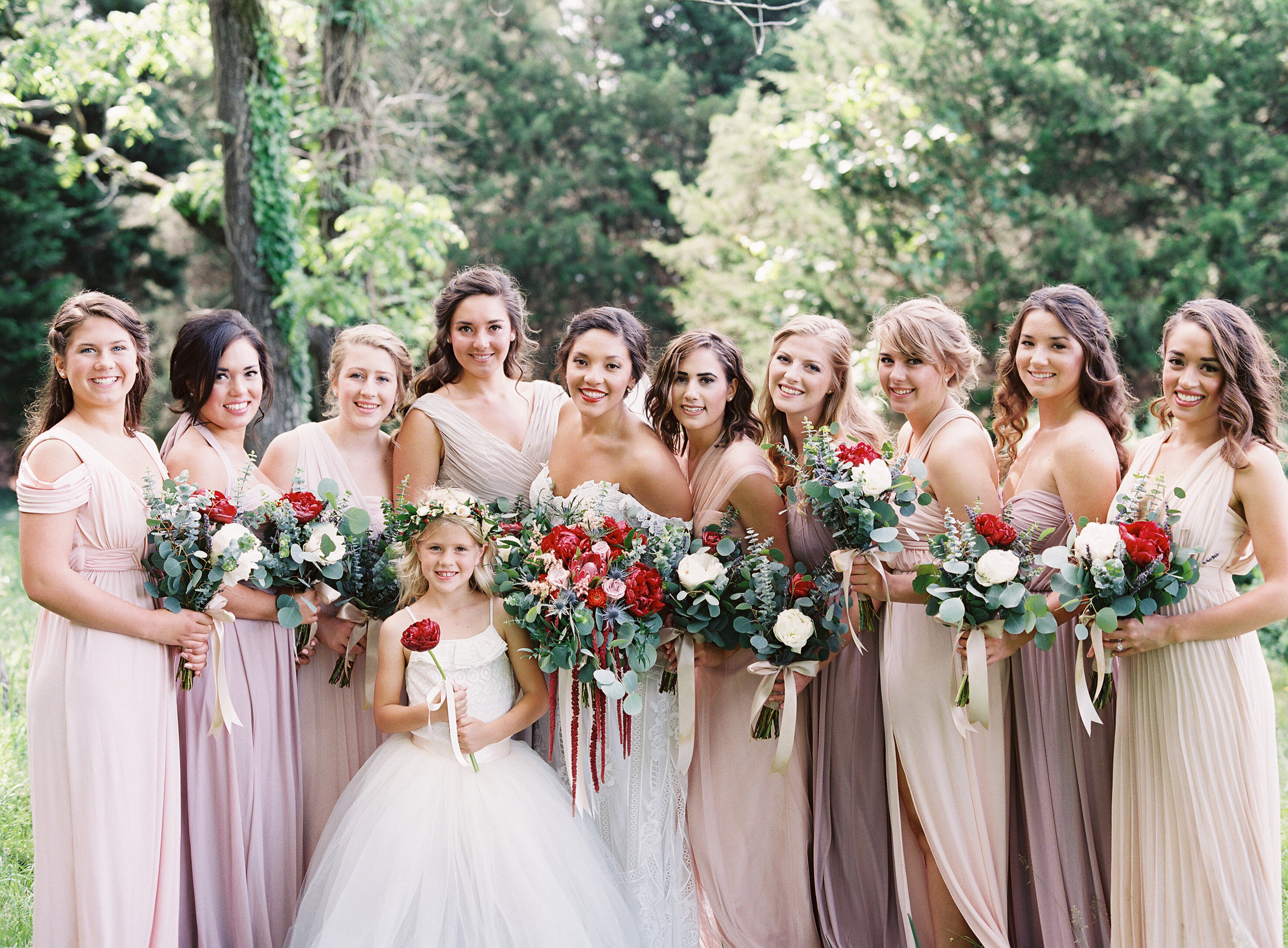 Mismatched bridesmaid gowns make bridal party portraits look fuller. I will never not love this trend! What a gorgeous group of ladies!!