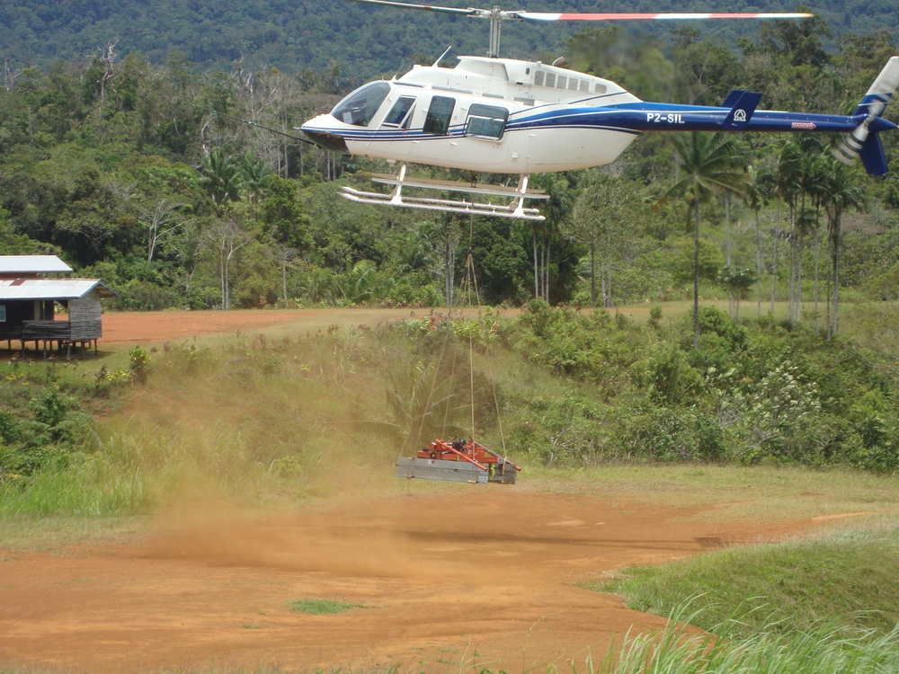 Helicopter with sawmill sling load, Papua New Guinea (PNG)