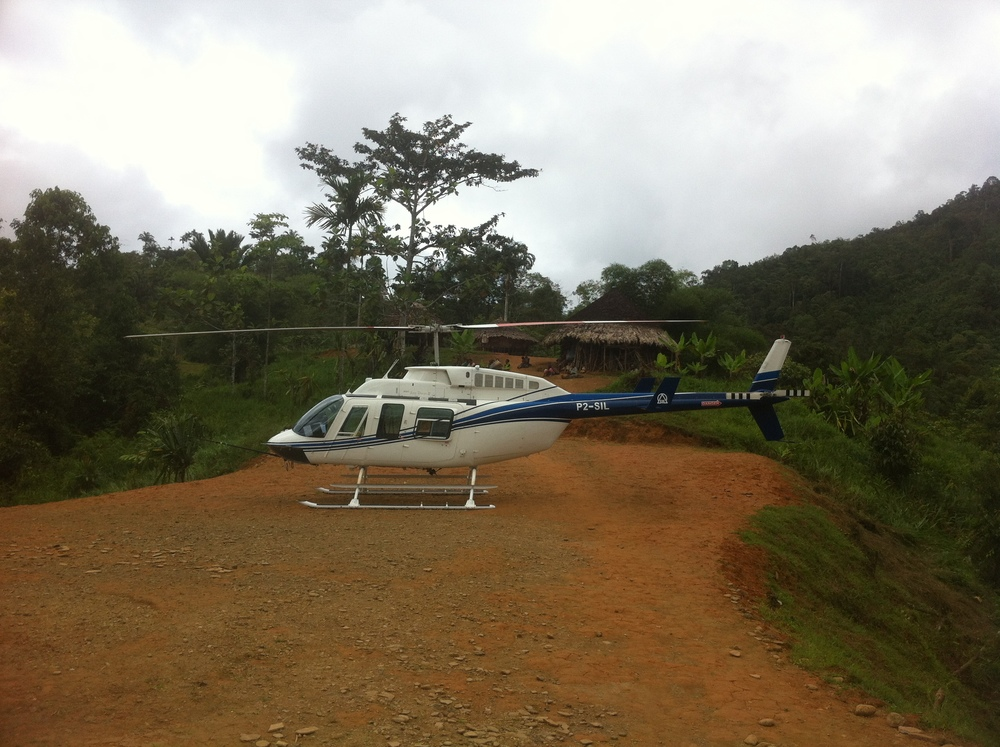 Helicopter on ridge for community development charter, Papua New Guinea (PNG)