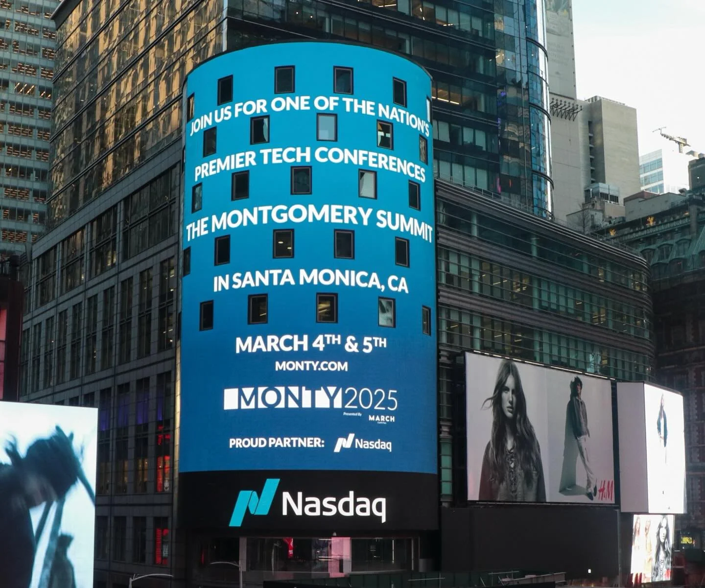 Digital billboard in Times Square announcing the Montgomery Summit, a tech conference in Santa Monica, California on March 4th and 5th, hosted by Monty.com and in partnership with Nasdaq, with a Nasdaq logo at the bottom.