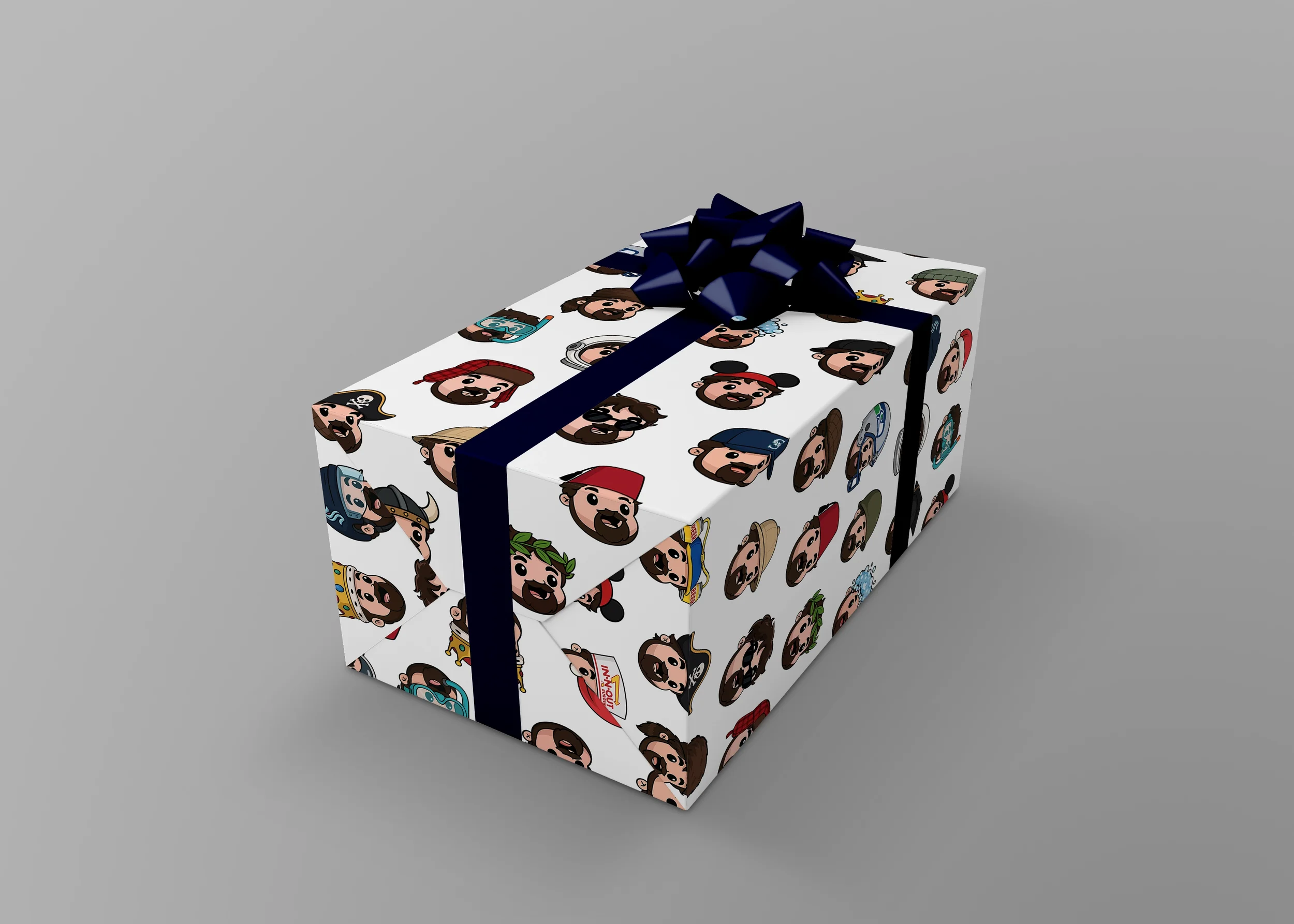 A gift box decorated with cartoon avatars of people in pirate, sailor, explorer, and adventurer costumes, wrapped with a dark blue ribbon and bow, sitting on a gray surface.