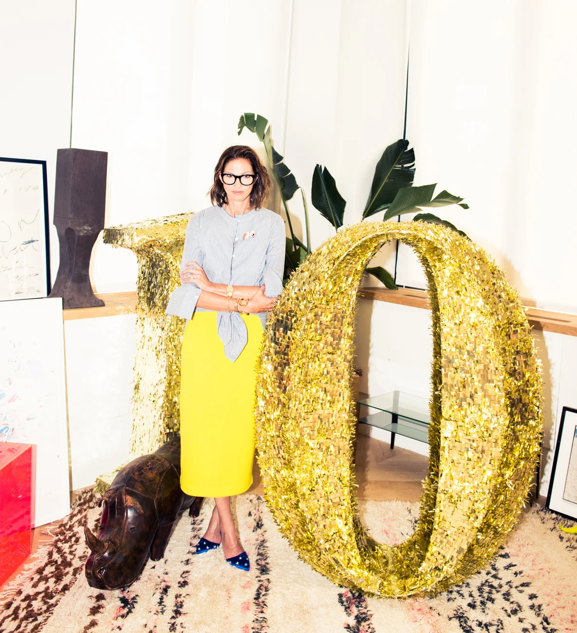 Lyons is wearing a Shirt by Céline ; Skirt by J.Crew ; Shoes by J.Crew and Glasses by Super Ciccio