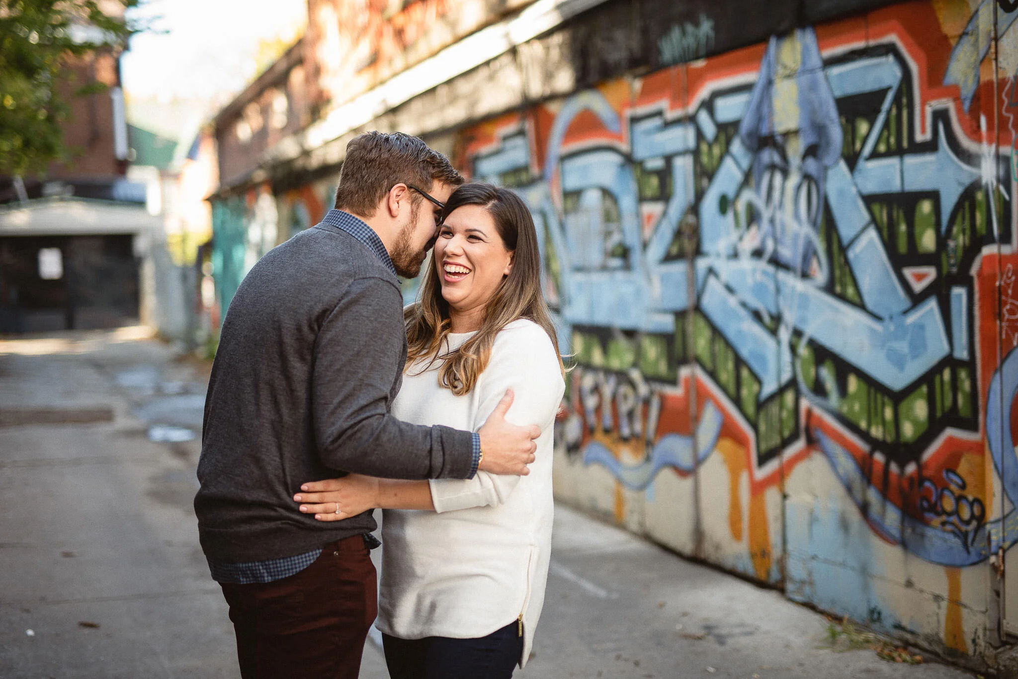 Engagement photos at Kensington Market next to Graffiti