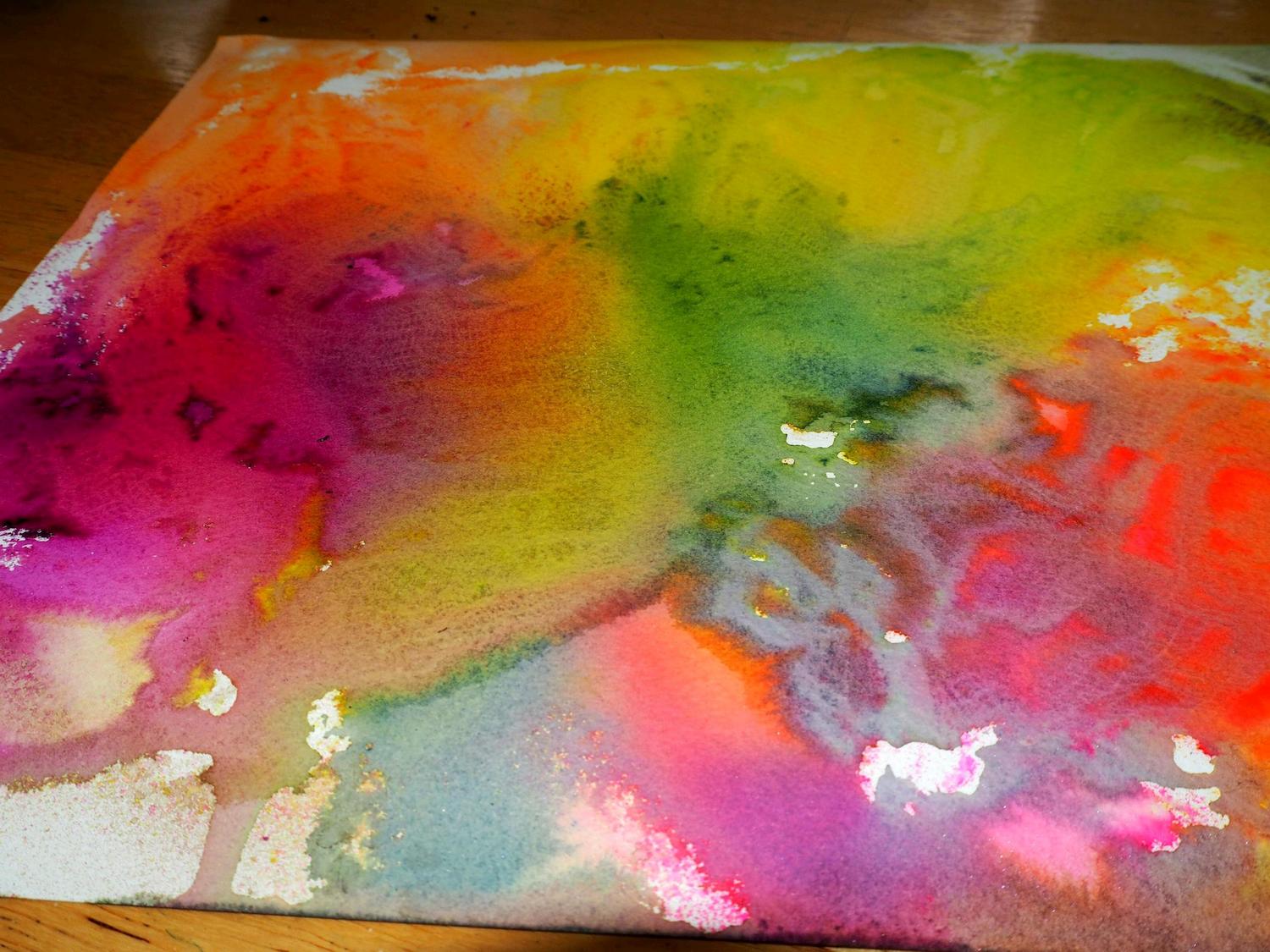 The leftover dyes on the watercolor paper I sprayed on top of. 