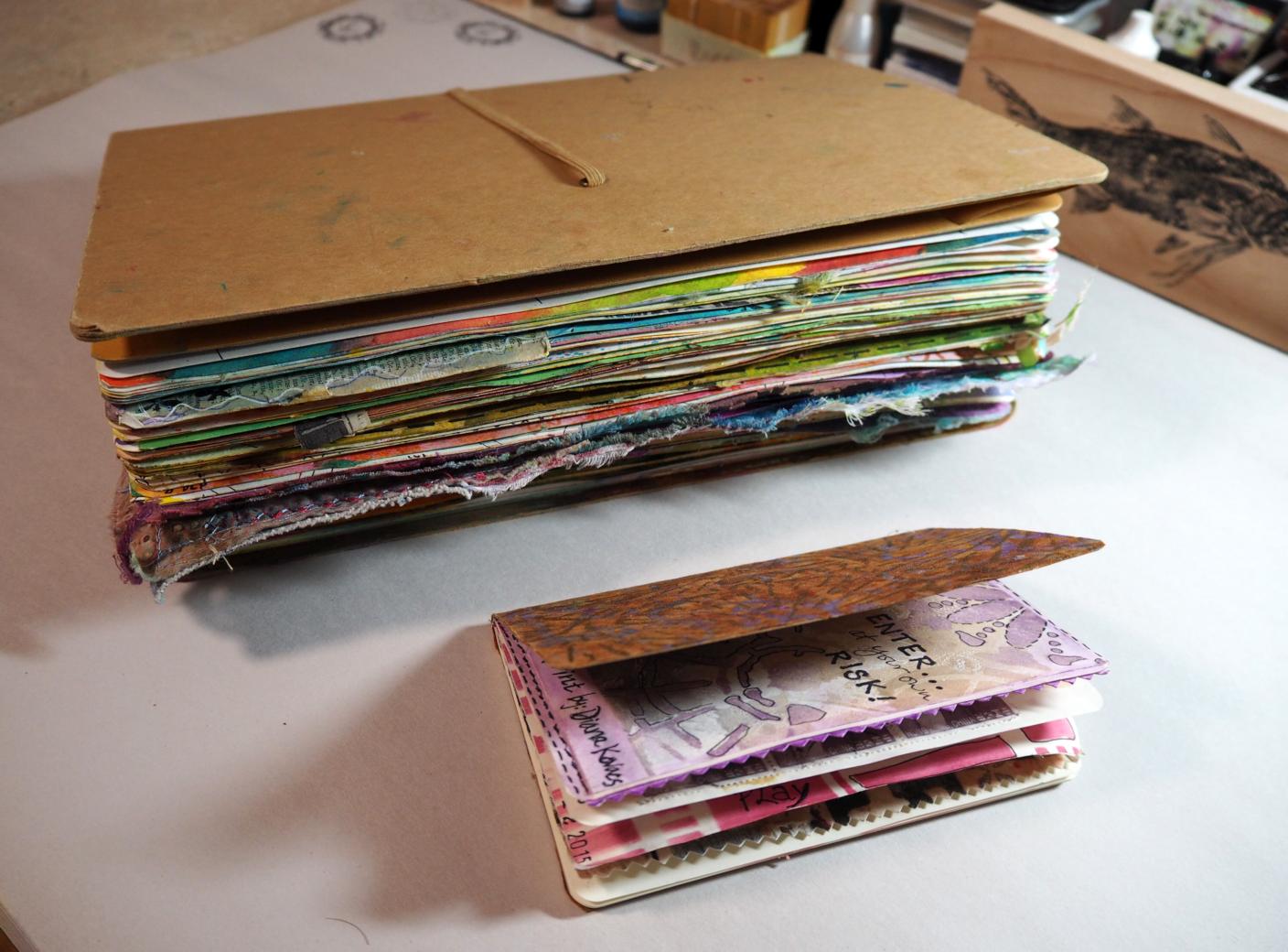 The difference in size between my larger 9" x 12" Dylusions art journal and my 3-1/2" x 5" moleskine journal . . . 